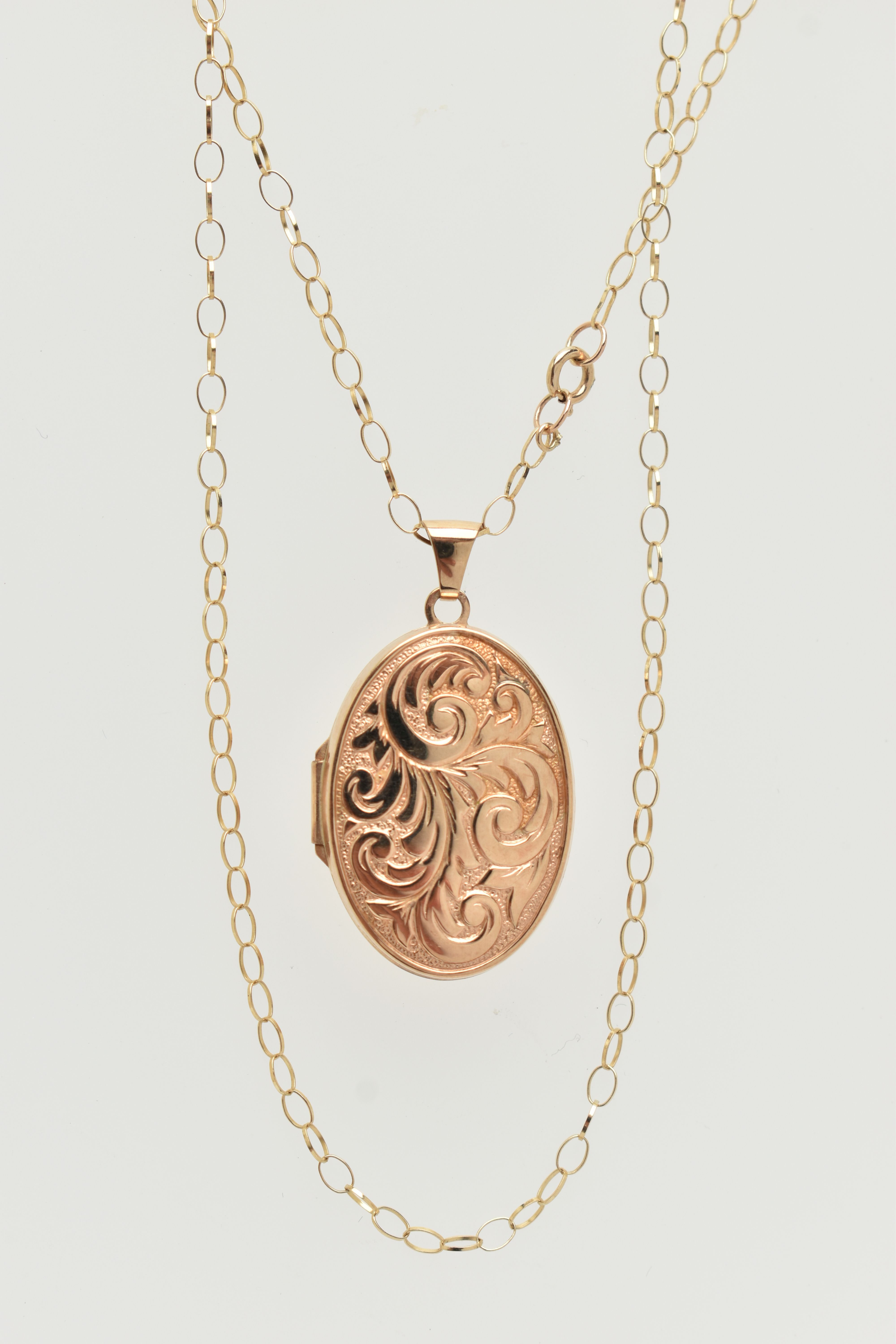 A 9CT GOLD LOCKET PENDANT AND CHAIN, oval floral pattern locket, opens to reveal two vacant