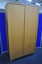 AN ERCOL SAVONA OAK TWO DOOR WARDROBE, enclosing an internal mirror to the right door, and a