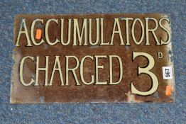 A GLASS WALL MOUNTED SIGN, 'Accumulators Charged 3D', black edged white lettering on brown