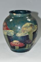 A MOORCROFT POTTERY 'CLAREMONT' DESIGN VASE, a red, green and purple mushroom design on a blue/green