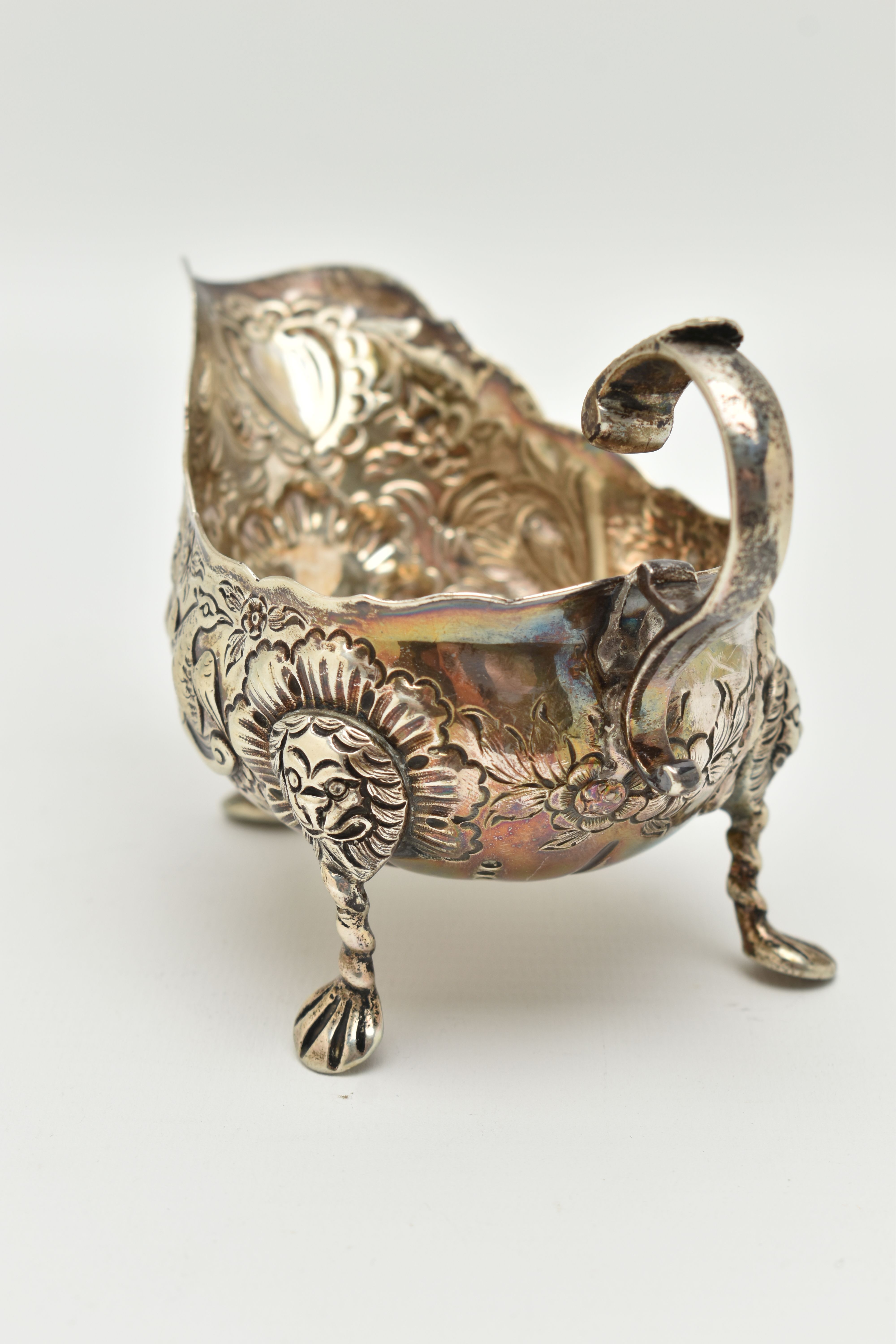 AN IRISH SILVER GRAVY BOAT, early 20th century, embossed animal and floral pattern, with three - Image 4 of 6