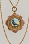 A 9CT GOLD MEDAL, a pigeon racing medal, designed with a ceramic painted pigeon to the centre,