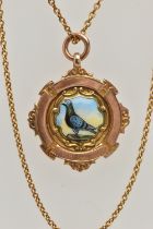 A 9CT GOLD MEDAL, a pigeon racing medal, designed with a ceramic painted pigeon to the centre,