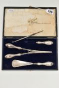 A CASED SILVER HANDLED SHOE HORN, BUTTON HOOK AND GLOVE STRETCHER SET, polished silver handles