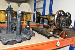 A LARGE ORNATE CAST IRON BOOT SCRAPER AND TWO SINGER SEWING MACHINES, comprising a Victorian cast