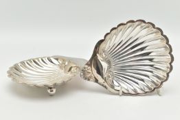TWO SILVER NUT DISHES, the first an Edward VII shell form nut dish, riased on three sperical feet,