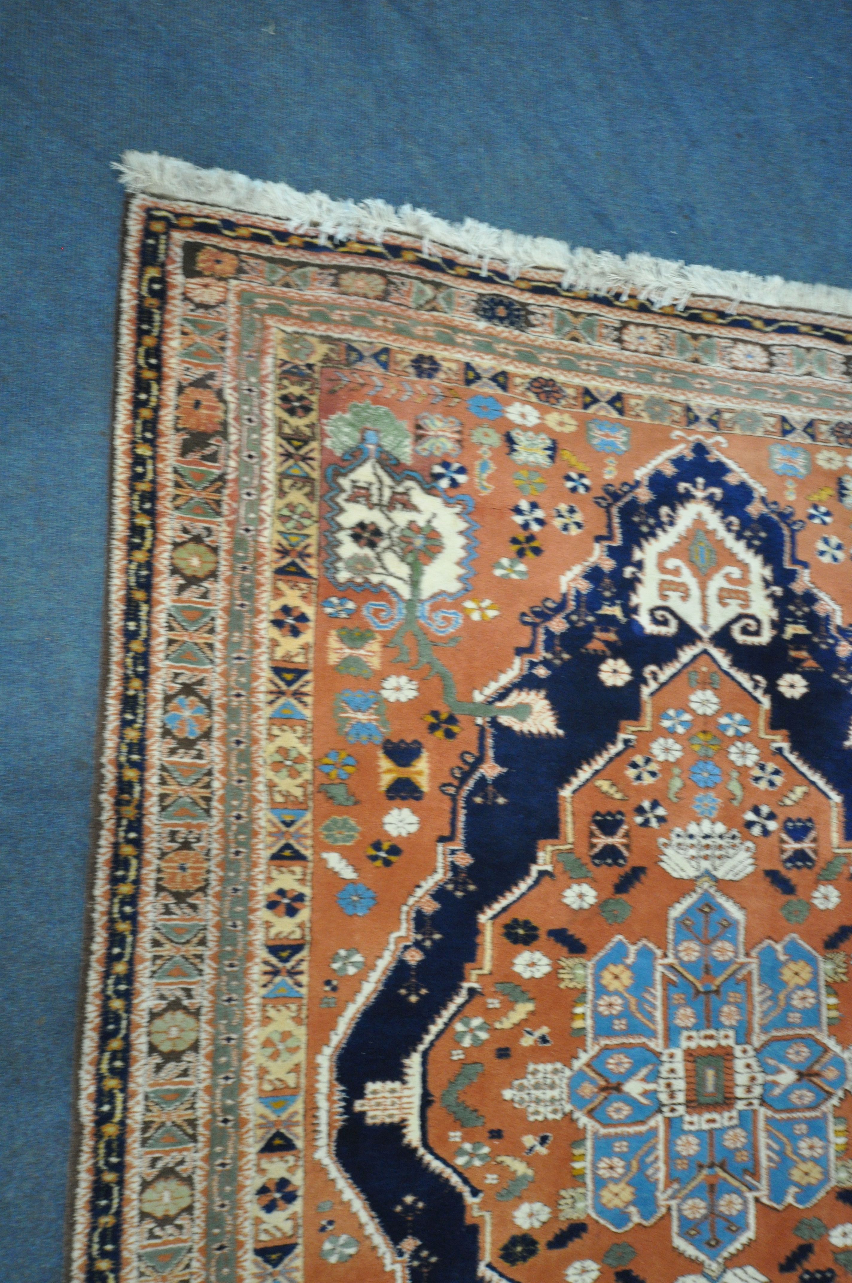 A RED GROUND PERSIAN RUG, with central medallion, repeating geometric and floral patterns, - Image 2 of 4