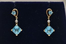 A PAIR OF YELLOW METAL TOPAZ AND DIAMOND DROP EARRINGS, each pendant set with a square cut topaz,