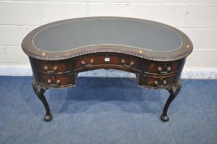 A 20TH CENTURY MAHOGANY KIDNEY SHAPED DESK, with blue leather writing surface, fitted with five