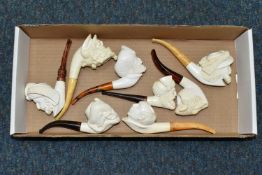 A BOX OF REPRODUCTION MEERSCHAUM PIPES, comprising eight pipes: five carved with different male