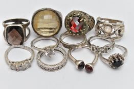 A BAG OF WHITE METAL RINGS, to include eleven rings in total, some set with stones, seven stamped