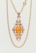 A 9CT GOLD PENDANT AND CHAIN, of an openwork scrolling design with a central oval imitation amber