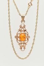 A 9CT GOLD PENDANT AND CHAIN, of an openwork scrolling design with a central oval imitation amber