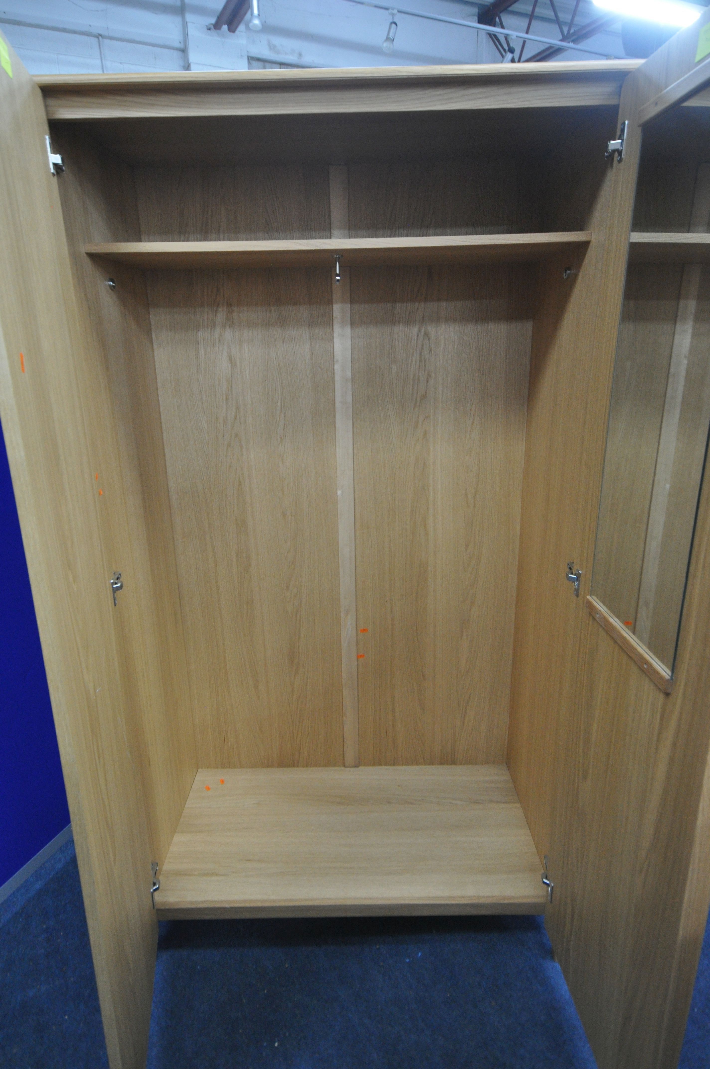 AN ERCOL SAVONA OAK TWO DOOR WARDROBE, enclosing an internal mirror to the right door, and a - Image 3 of 4