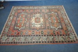 A RED GROUND PERSIAN RUG, with central medallions, repeating geometric patterns and multi-strap