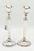 A PAIR OF EARLY 20TH CENTURY CANDLESTICKS, tapering stems, on round weighted bases, hallmarked 'A