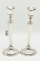 A PAIR OF EARLY 20TH CENTURY CANDLESTICKS, tapering stems, on round weighted bases, hallmarked 'A