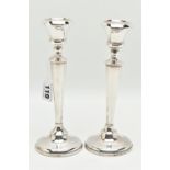 A PAIR OF EARLY 20TH CENTURY CANDLESTICKS, tapering stems, on round weighted bases, hallmarked 'A