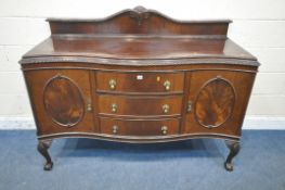 A 20TH CENTURY MAHOGANY SERPENTINE SIDEBOARD, with a raised back, fitted with double cupboard doors,
