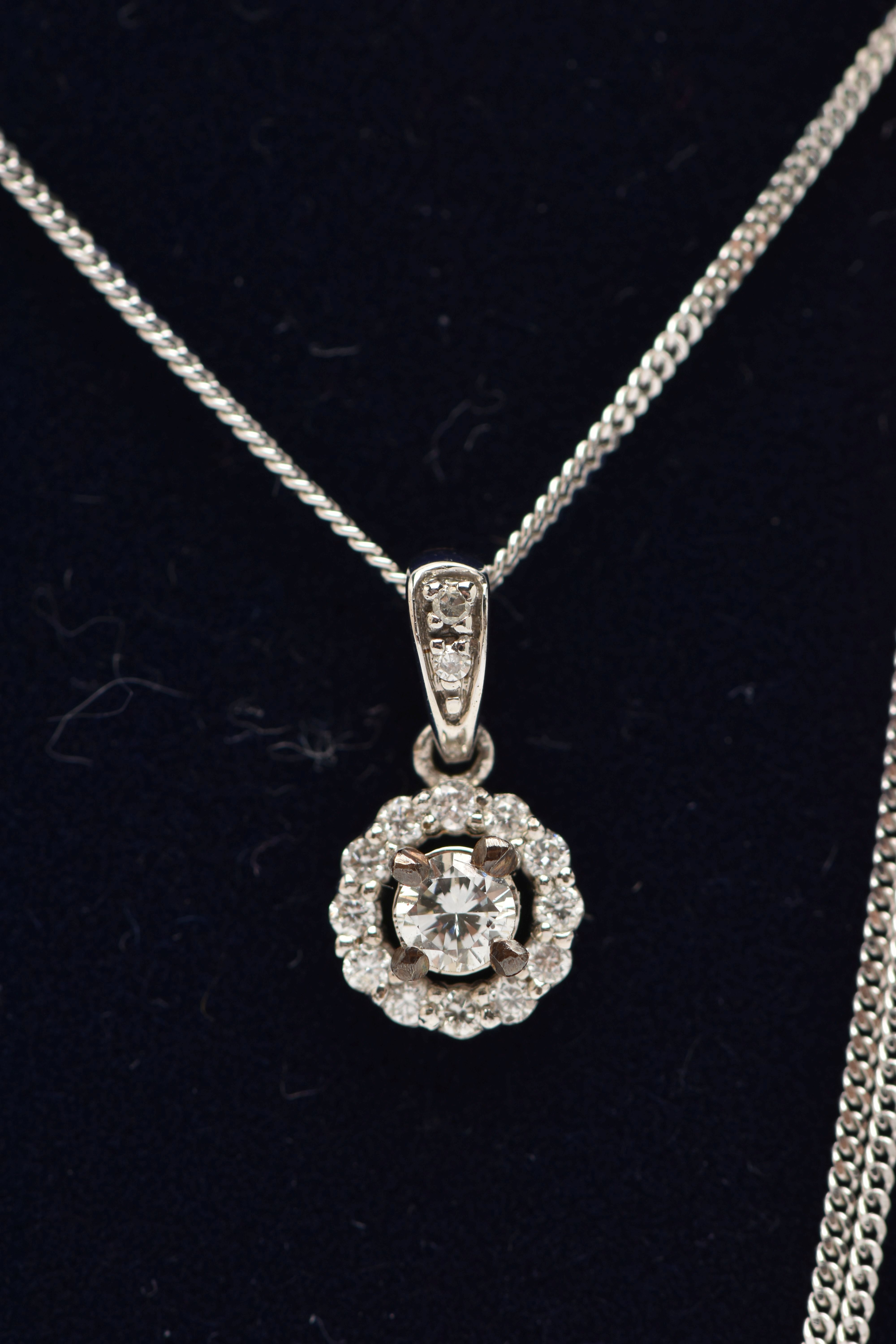 A 9CT WHITE GOLD DIAMOND PENDANT AND WHITE METAL CHAIN, a circular cluster pendant, set with a - Image 2 of 4