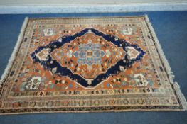 A RED GROUND PERSIAN RUG, with central medallion, repeating geometric and floral patterns,