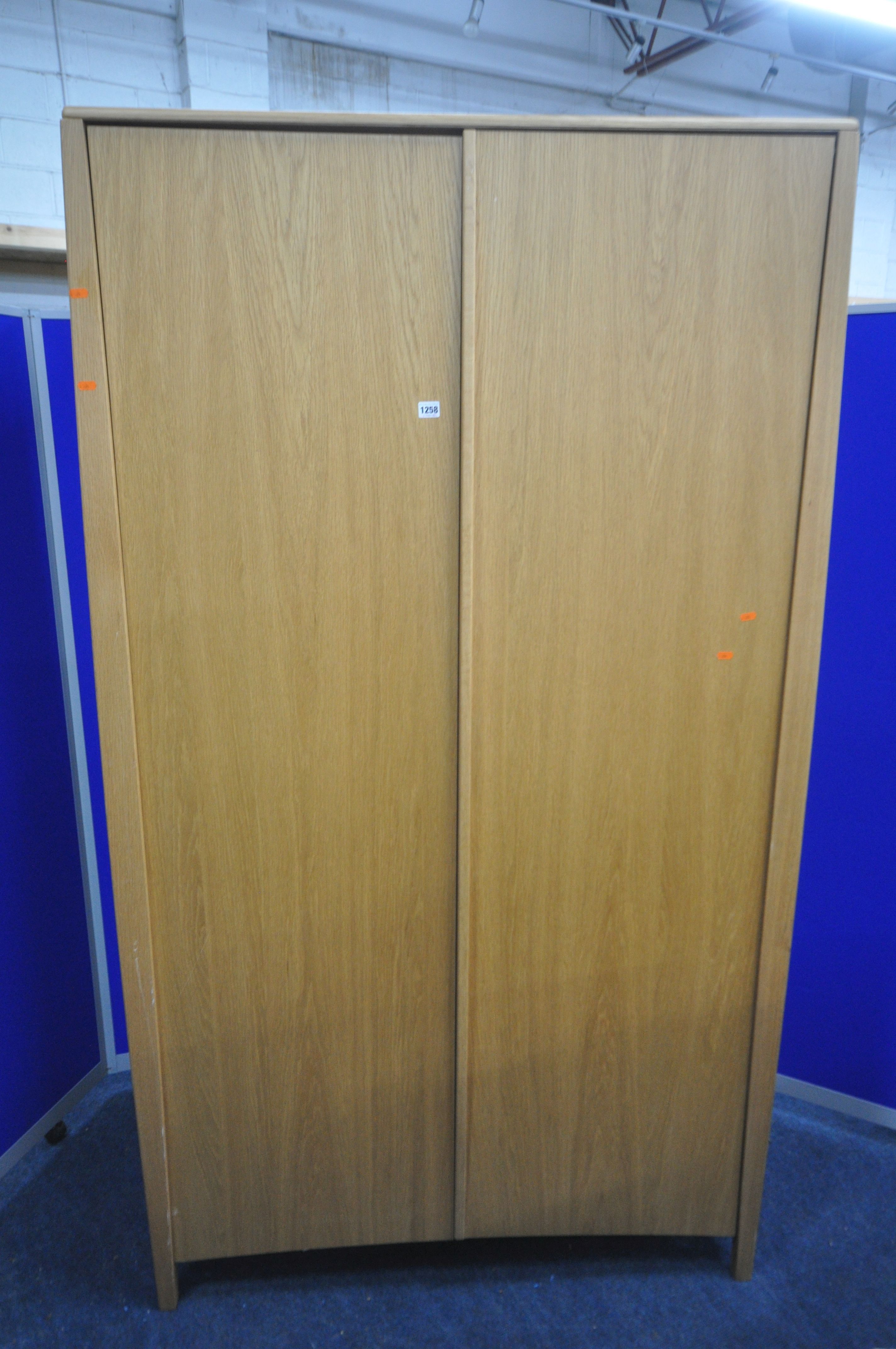 AN ERCOL SAVONA OAK TWO DOOR WARDROBE, enclosing an internal mirror to the right door, and a - Image 2 of 4