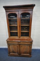 A 19TH CENTURY MAHOGANY BOOKCASE, the top with double glazed doors, that's enclosing three