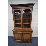 A 19TH CENTURY MAHOGANY BOOKCASE, the top with double glazed doors, that's enclosing three