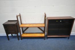 HERBERT GIBBS, A MID CENTURY TEAK BOOKCASE, with double smoked glass doors, that are enclosing two