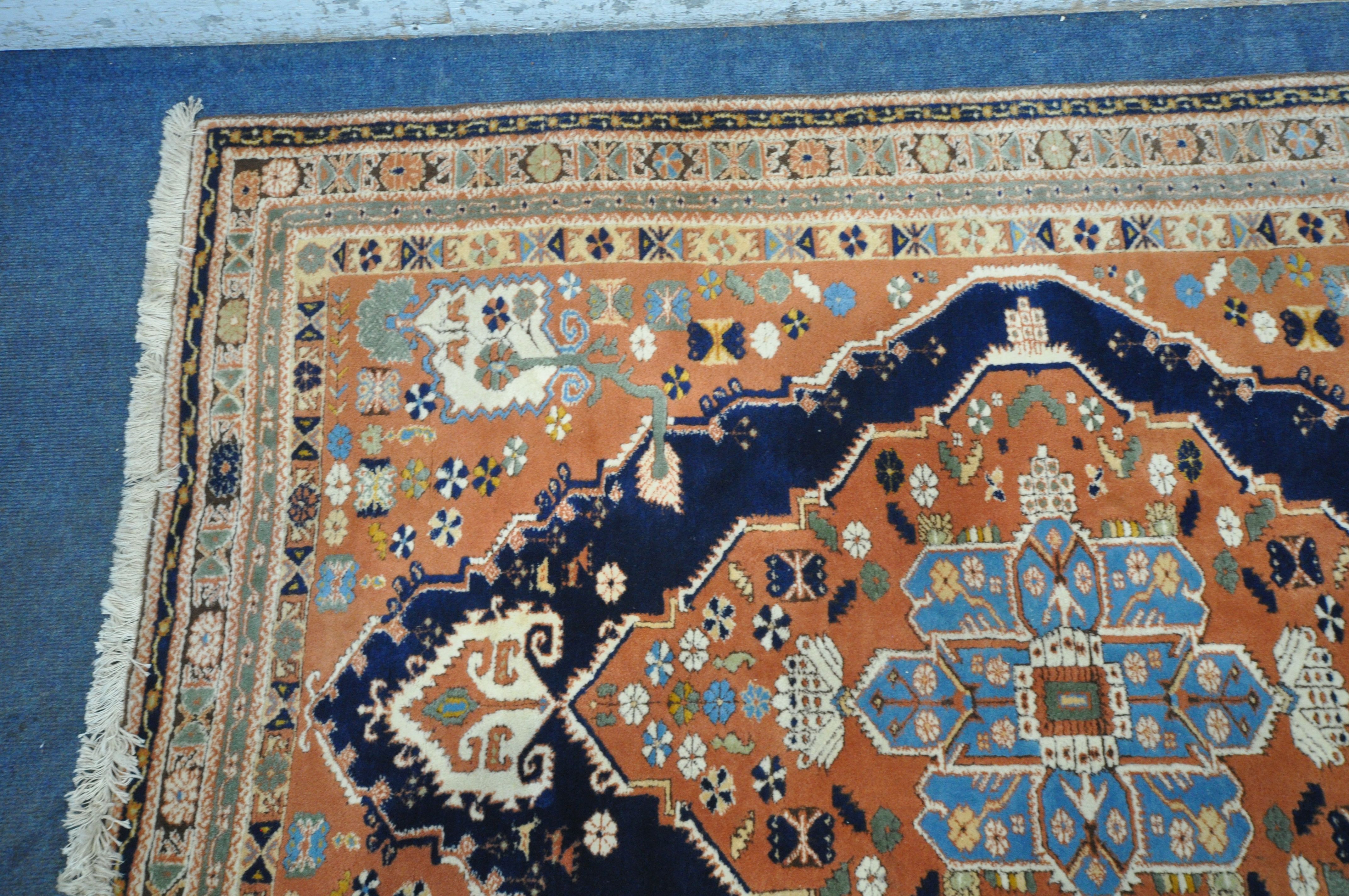 A RED GROUND PERSIAN RUG, with central medallion, repeating geometric and floral patterns, - Image 3 of 4