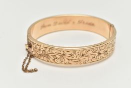 A 9CT ROLLED GOLD HINGED BANGLE, floral detailed bangle, fitted with a push piece clasp with