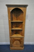 A 20TH CENTURY PINE CORNER CUPBOARD, with a single cupboard door and an arrangement of shelves,