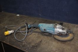 A MAKITA A9020 110V 9in ANGLE GRINDER with key (working but slow to start, spindle lock stiff)
