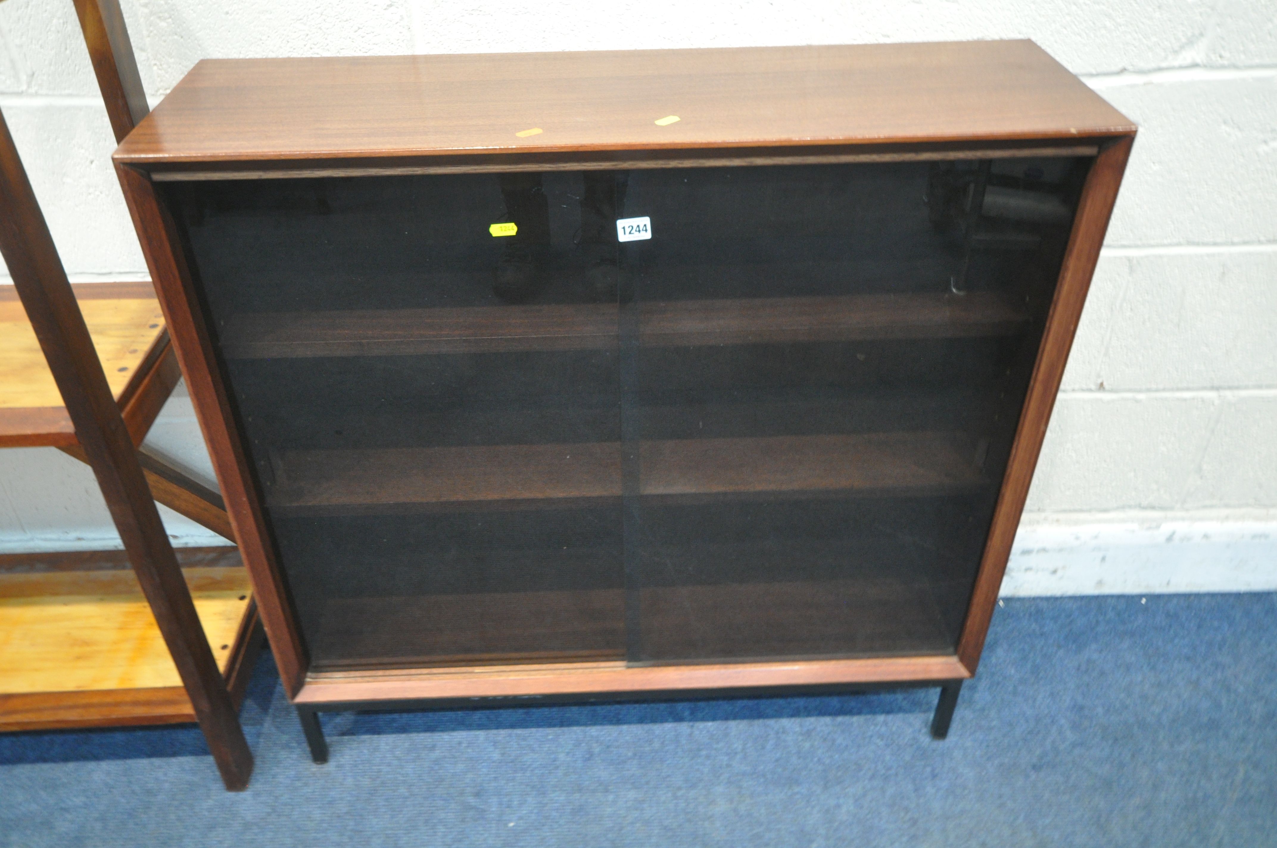 HERBERT GIBBS, A MID CENTURY TEAK BOOKCASE, with double smoked glass doors, that are enclosing two - Image 2 of 3