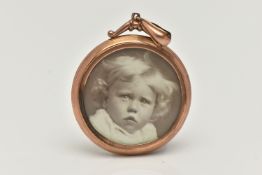 A DOUBLE SIDED PHOTO PENDANT, a large rose metal photo pendant, fitted with a large tapered bail,