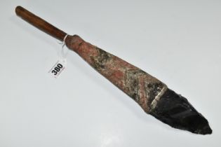 TRIBAL INTEREST: AN OBSIDIAN KNIFE ON A PAINTED WOODEN SHAFT, the wooden shaft carved with geometric