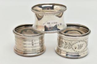 THREE SILVER NAPKIN RINGS, all of different design, all with beaded edge detail, hallmarks for