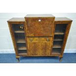 AN ART DECO WALNUT COCKTAIL CABINET, fitted with two glazed doors with geometric etching, flanking a