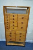 A 20TH CENTURY PINE APOTHECARY CABINET, with an arrangement of twenty-three drawers, the top section