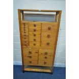 A 20TH CENTURY PINE APOTHECARY CABINET, with an arrangement of twenty-three drawers, the top section