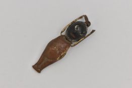 A WWI FUMSUP CHARM, wooden head and metal body with moveable arms, approximate length 31mm, (