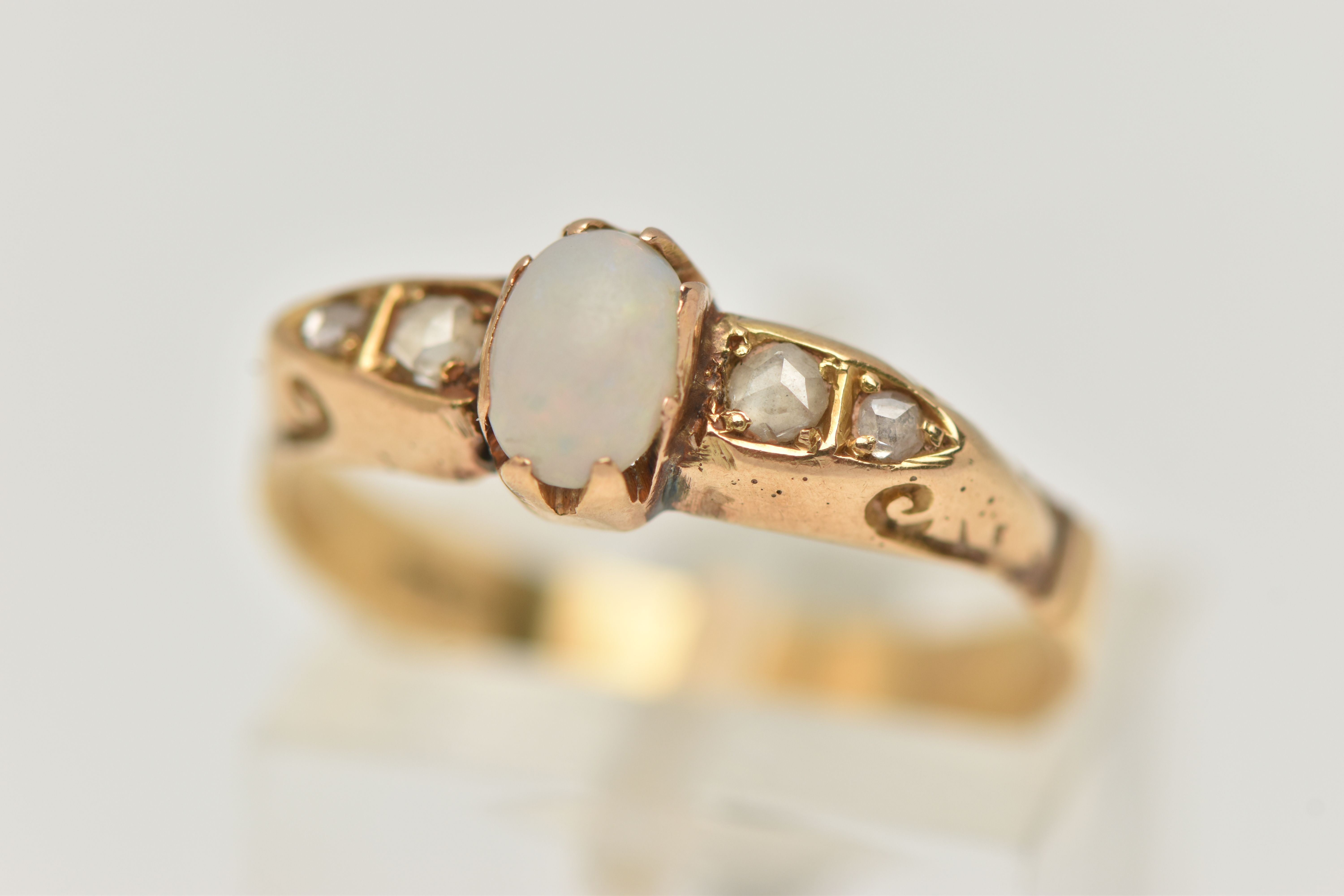 A YELLOW METAL OPAL AND DIAMOND RING, set with a central oval cut opal cabochon (abraded), measuring