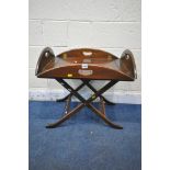 A 20TH CENTURY MAHOGANY CAMPAIGN BUTLERS TRAY TABLE, with a folding frame, width 64cm x depth 49cm x