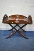 A 20TH CENTURY MAHOGANY CAMPAIGN BUTLERS TRAY TABLE, with a folding frame, width 64cm x depth 49cm x