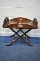 A 20TH CENTURY MAHOGANY CAMPAIGN BUTLERS TRAY TABLE, with a folding frame, width 64cm x depth 49cm x