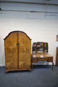 A 20TH CENTURY BURR WALNUT DOUBLE DOOR WARDROBE, with an arched top, raised on cabriole legs,