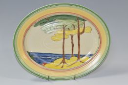 A NEWPORT POTTERY OVAL 'GREEN FIRS' PATTERN MEAT PLATE, painted with stylised tree in a coastal