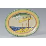 A NEWPORT POTTERY OVAL 'GREEN FIRS' PATTERN MEAT PLATE, painted with stylised tree in a coastal