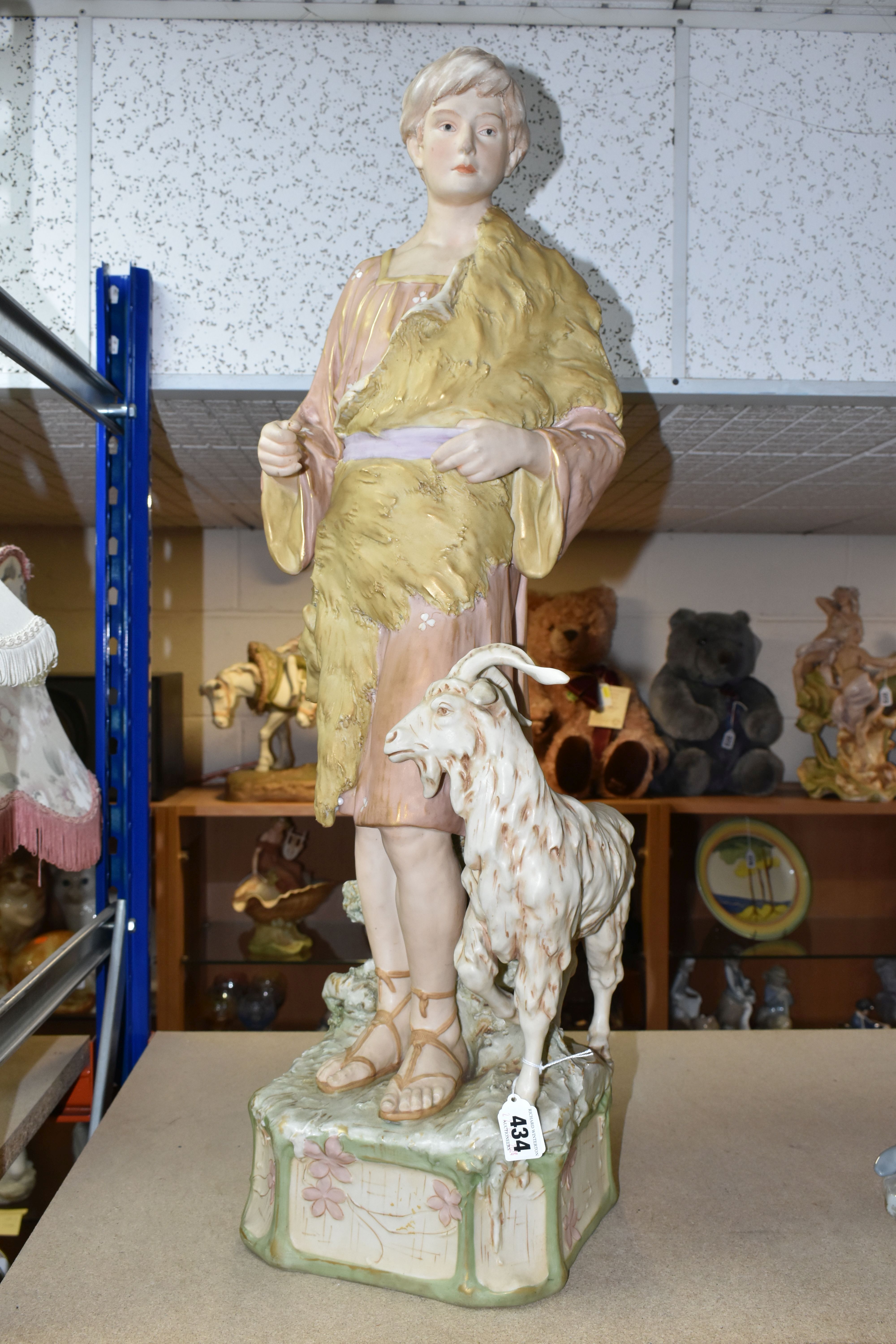 A ROYAL DUX SCULPTURE OF A GOATHERD WITH A GOAT, pink makers mark and impressed numbers 1061 to