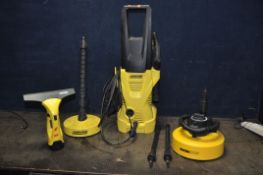 A KARCHER K2 PRESSURE WASHER with lance, two attachment, patio attachment (PAT pass and working),